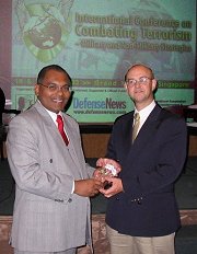Rohan Guneratna, world authority on Al Qaeda, presents the award to Dr. Coburn