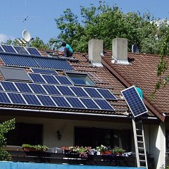 Solar panels being fitted on roof